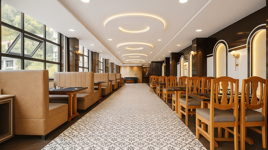 Interior of the Royal potala by orsino dining hall featuring rows of wooden tables and chairs, patterned flooring, and a decorative ceiling.