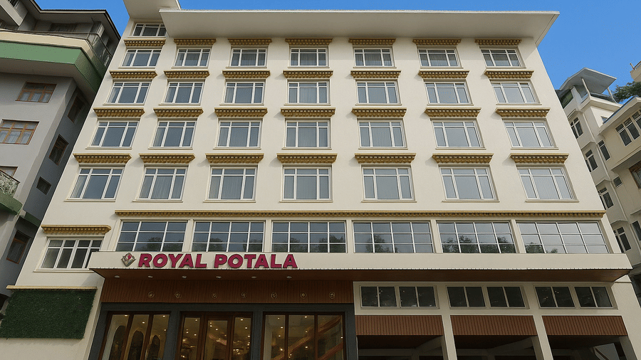 The multi-storey exterior facade of the Royal Potala by Orsino building, showcasing a modern architectural design with a prominent red sign above the entrance.