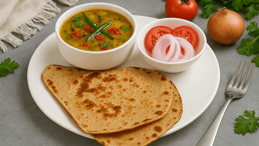 Dal with chapati, sliced onions, tomato, and green garnish served at Tisya Farms, Gurgao