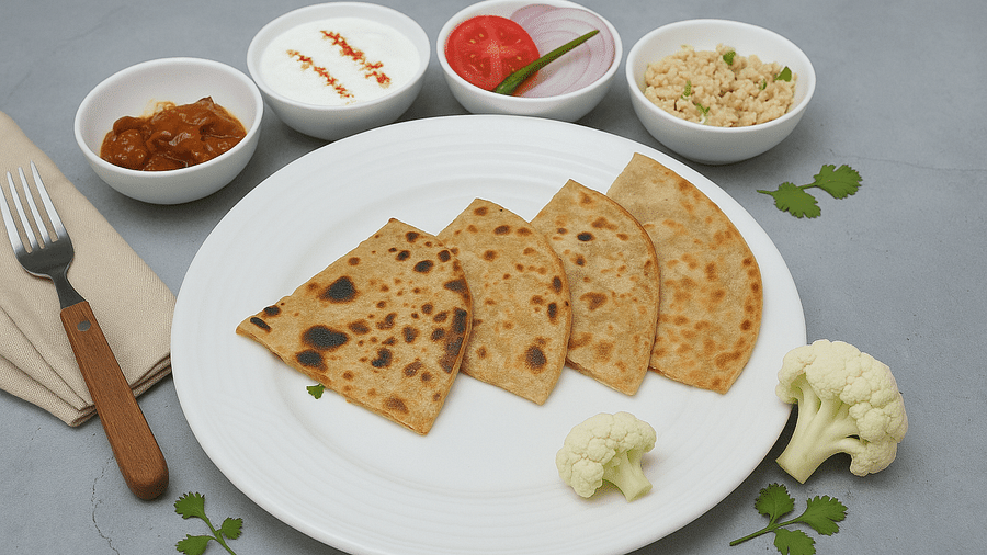 Plate of parathas with butter, curd, pickle, and salad at Tisya Farms, Gurgaon.
