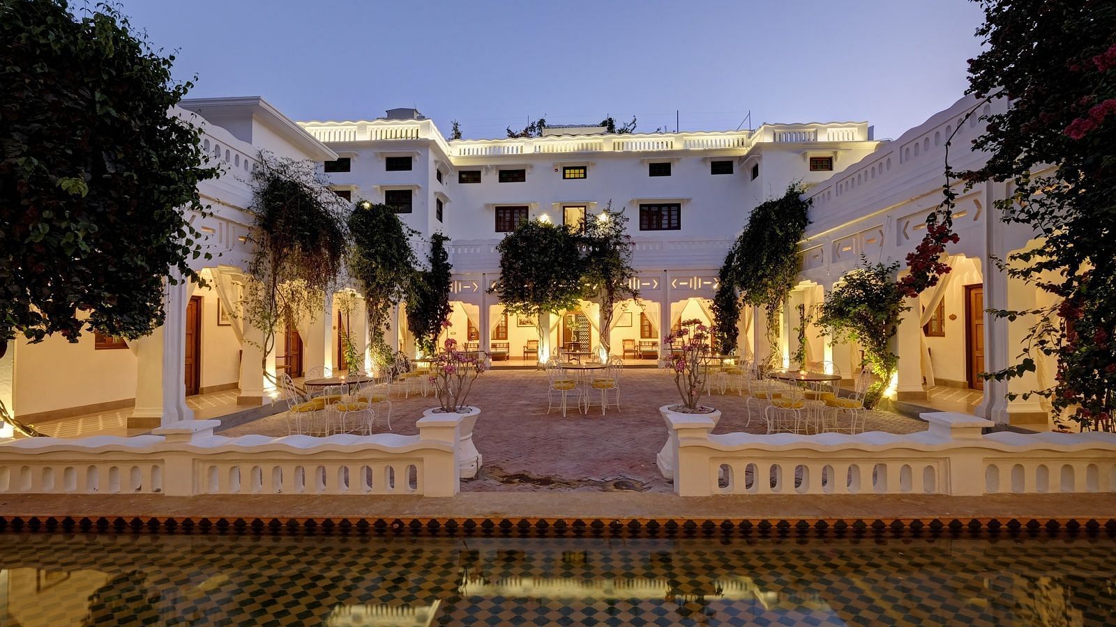 A wide view of the central courtyard at Saraca Hotel, Lucknow during blue hour