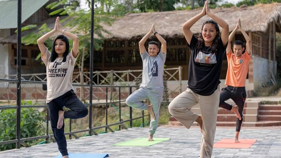People doing yoga at Summit Green Lake Tea Resort & Spa, Kaziranga