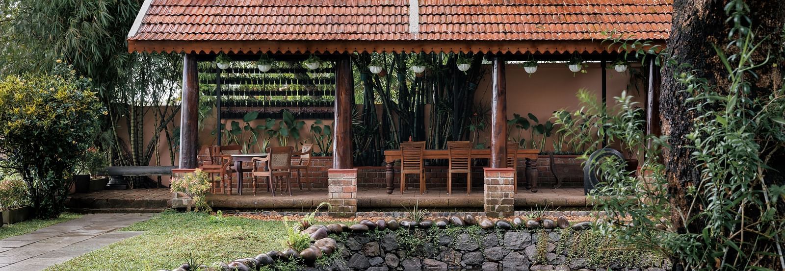 A facade image showcasing the pond at BluSalzz Villas - Muhamma Resort, Alleppey and the outdoor seating area of the restaurant