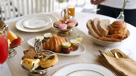 A breakfast table arrangement in the outdoor patio area of Dileep Kothi, Jaipur