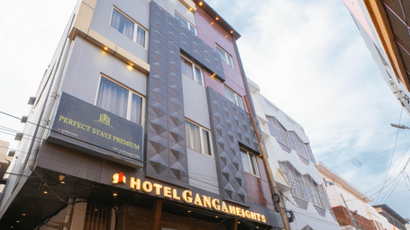 Exterior view of the multi-storey hotel building under a bright sky from a low angle - Perfectstayz Premium at Har Ki Pauri Road (Ganga Heights)