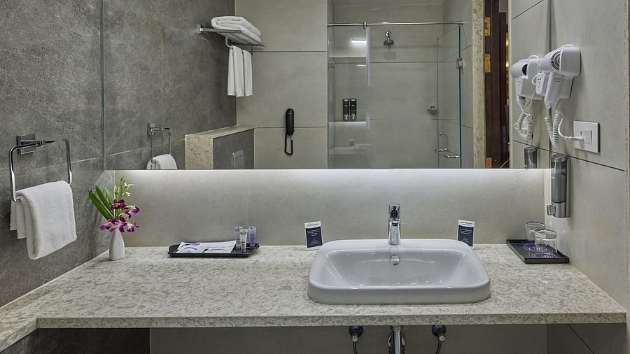Sink area with the mirror inside the suite at Grand Continent - A Sarovar Premiere Affiliate Hotel, Hosur