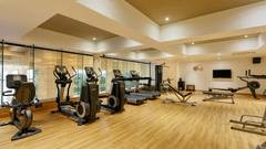 An overview of the the gym with many equipments inside - Karma Lakelands.