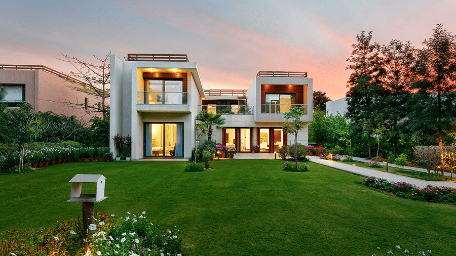 The facade of one of the Villas at Karma Lakelands, with trees surrounding it.