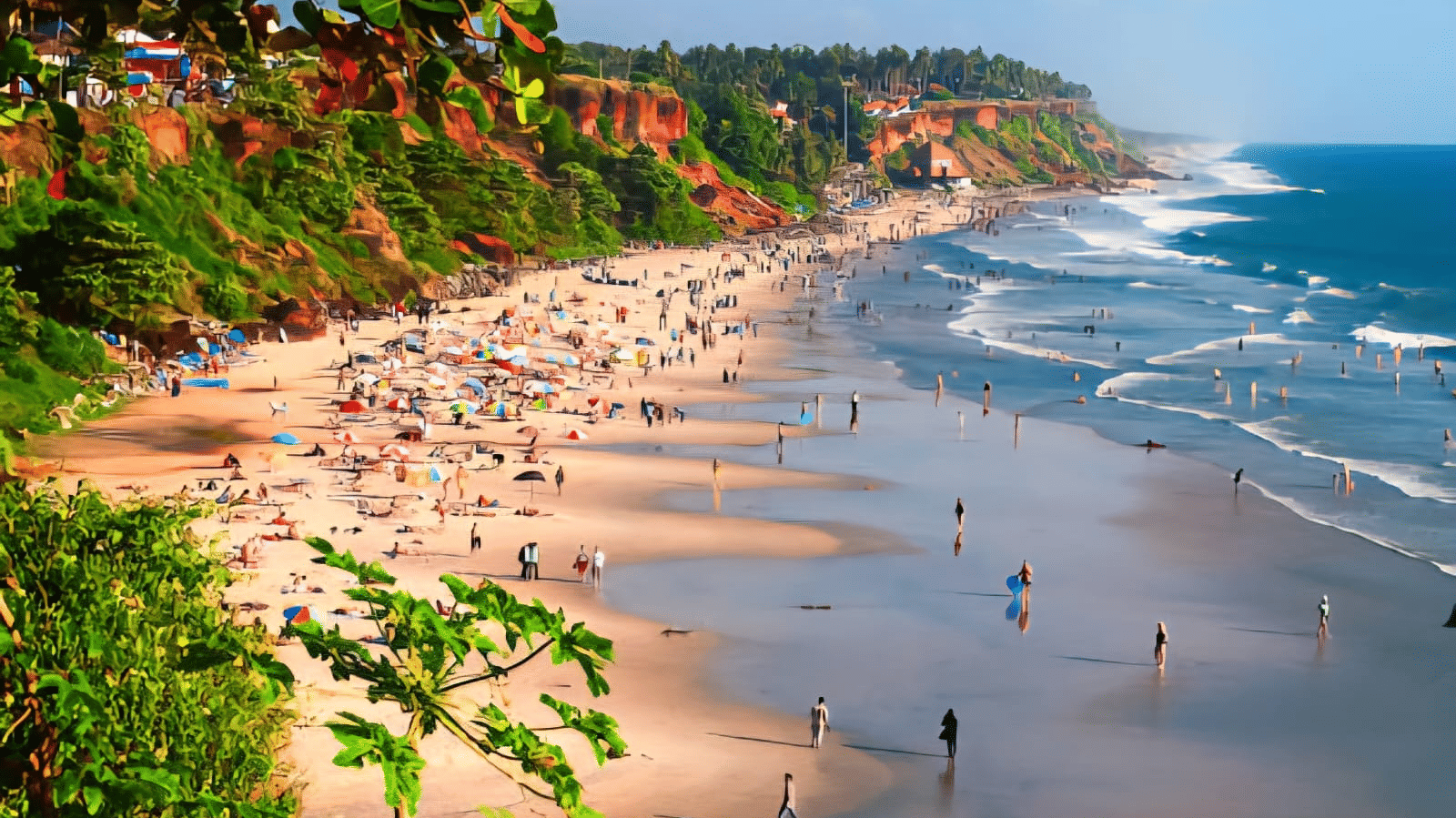 Busy tropical beach with a long stretch of sand, colourful umbrellas, and red laterite cliffs in the background.