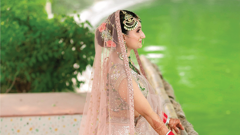 A bride posing for a picture outdoors - Karma Lakelands.