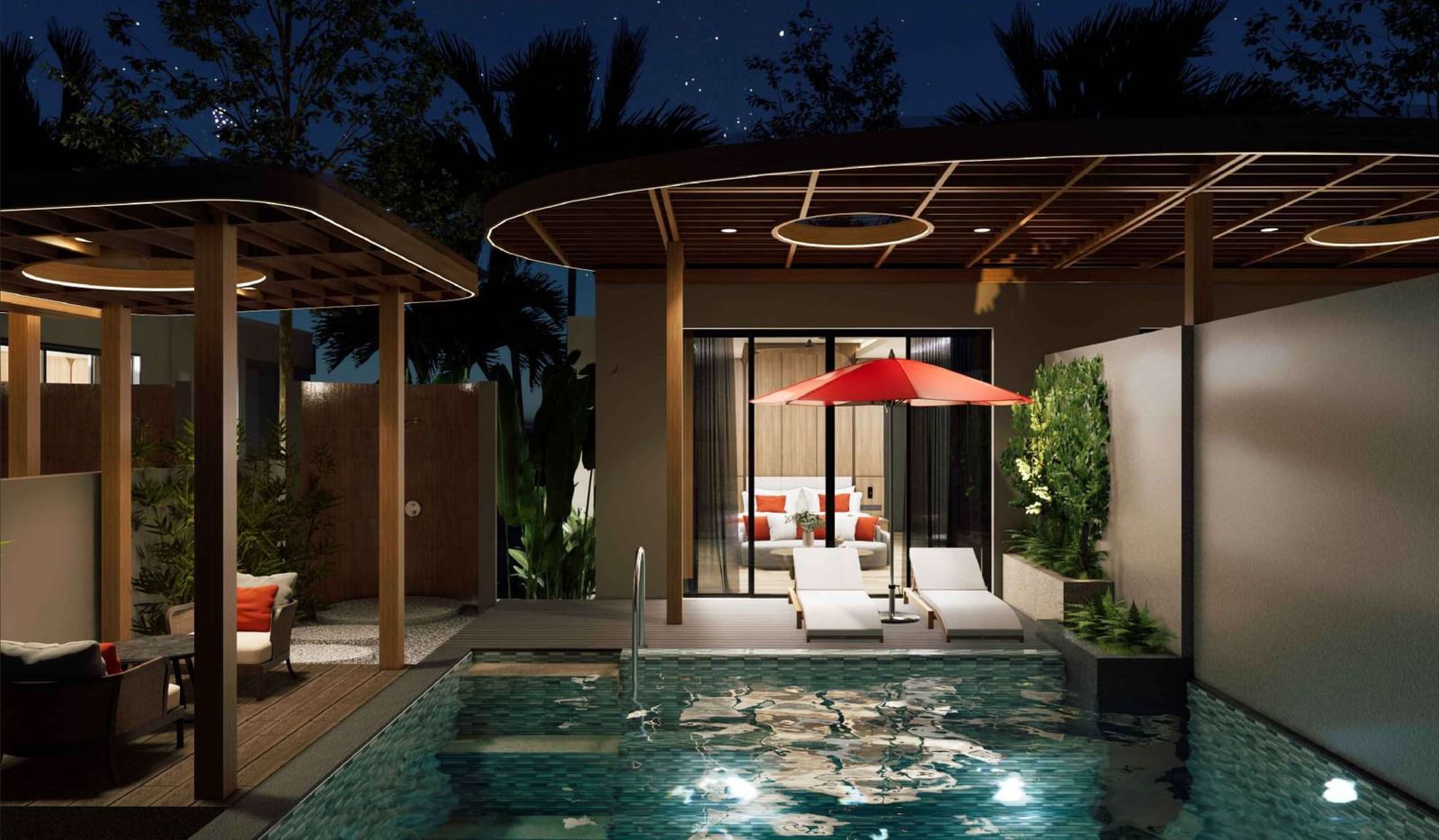 A nighttime view of the private pool villa at Ramada Resort by Wyndham Khao Lak, with the pool lit up and stars in the sky.