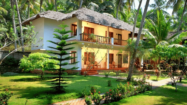 Facade image of Abad Harmonia, Kovalam in front of a garden surrounded by many trees