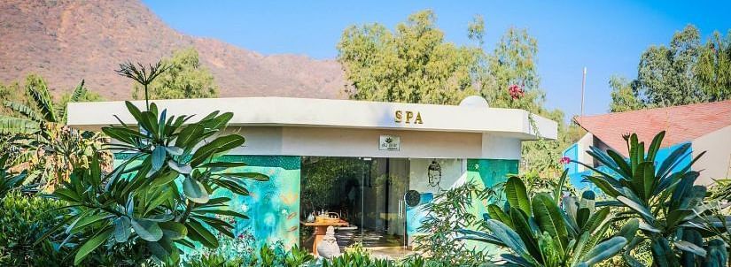 A building with SPA signage, surrounded by lush greenery.