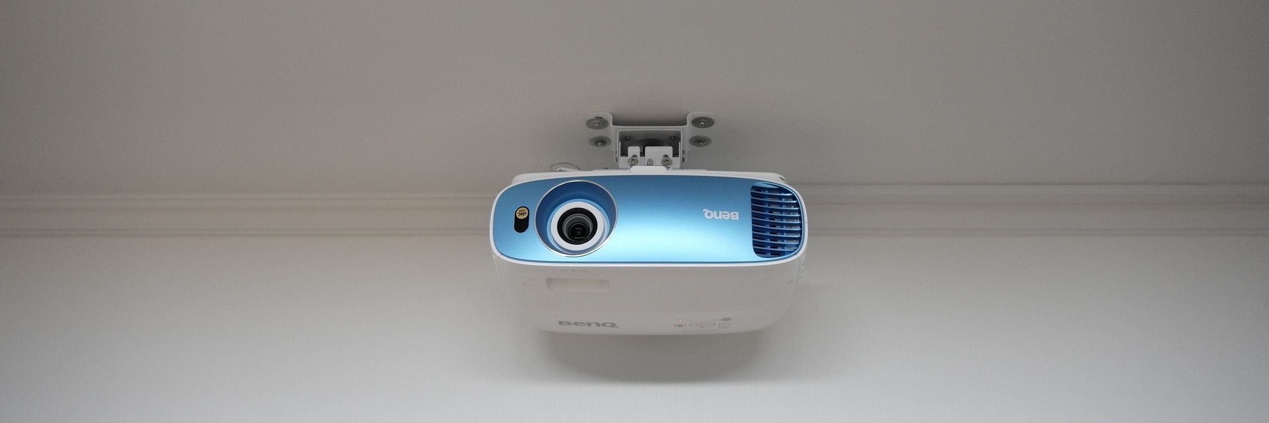 A blue coloured wall mounted projector in our meeting hall - Stone Wood Nature Resort, Gokarna