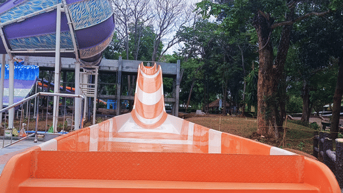 A straight single-lane water slide, with an exciting slope for a thrilling ride - Black Thunder