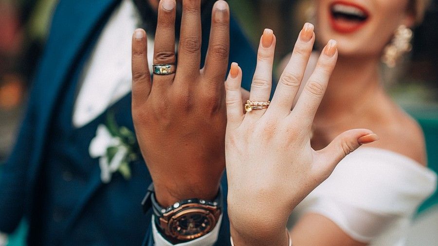 couple showing off rings