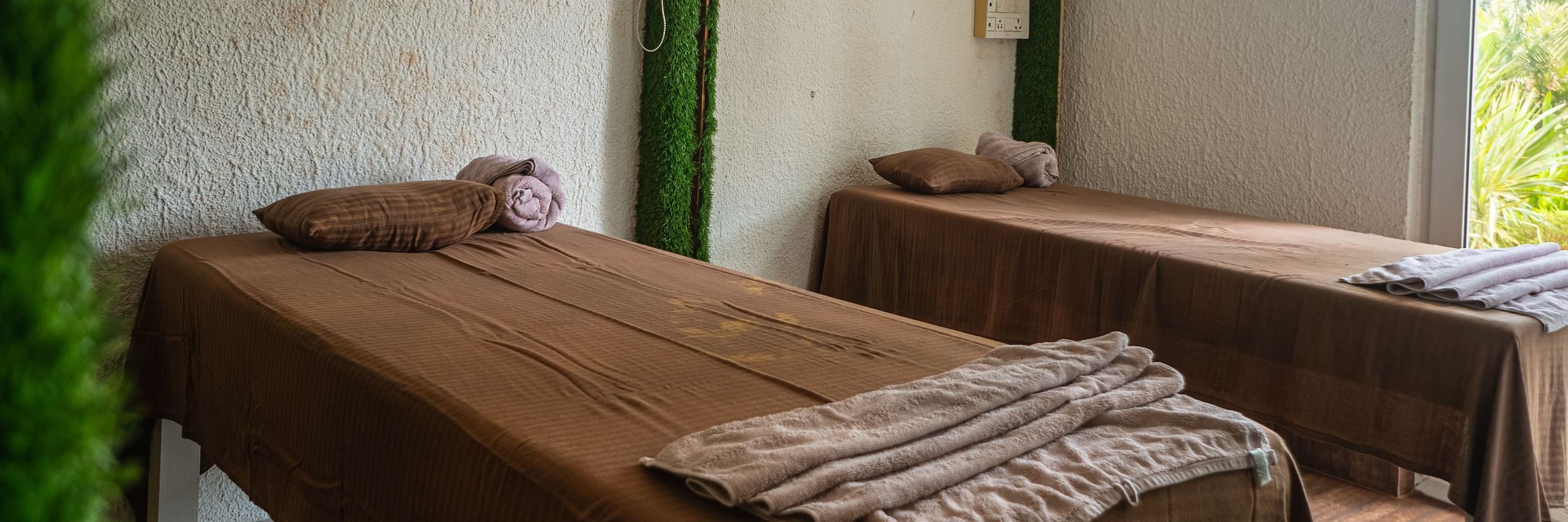 Two single beds placed inside our spa in Mandrem 