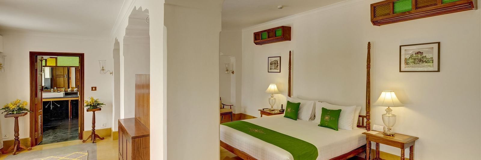 Imperial Suite at Saraca Hotel, Lucknow with a double bed and a large, open living space with arched pillars