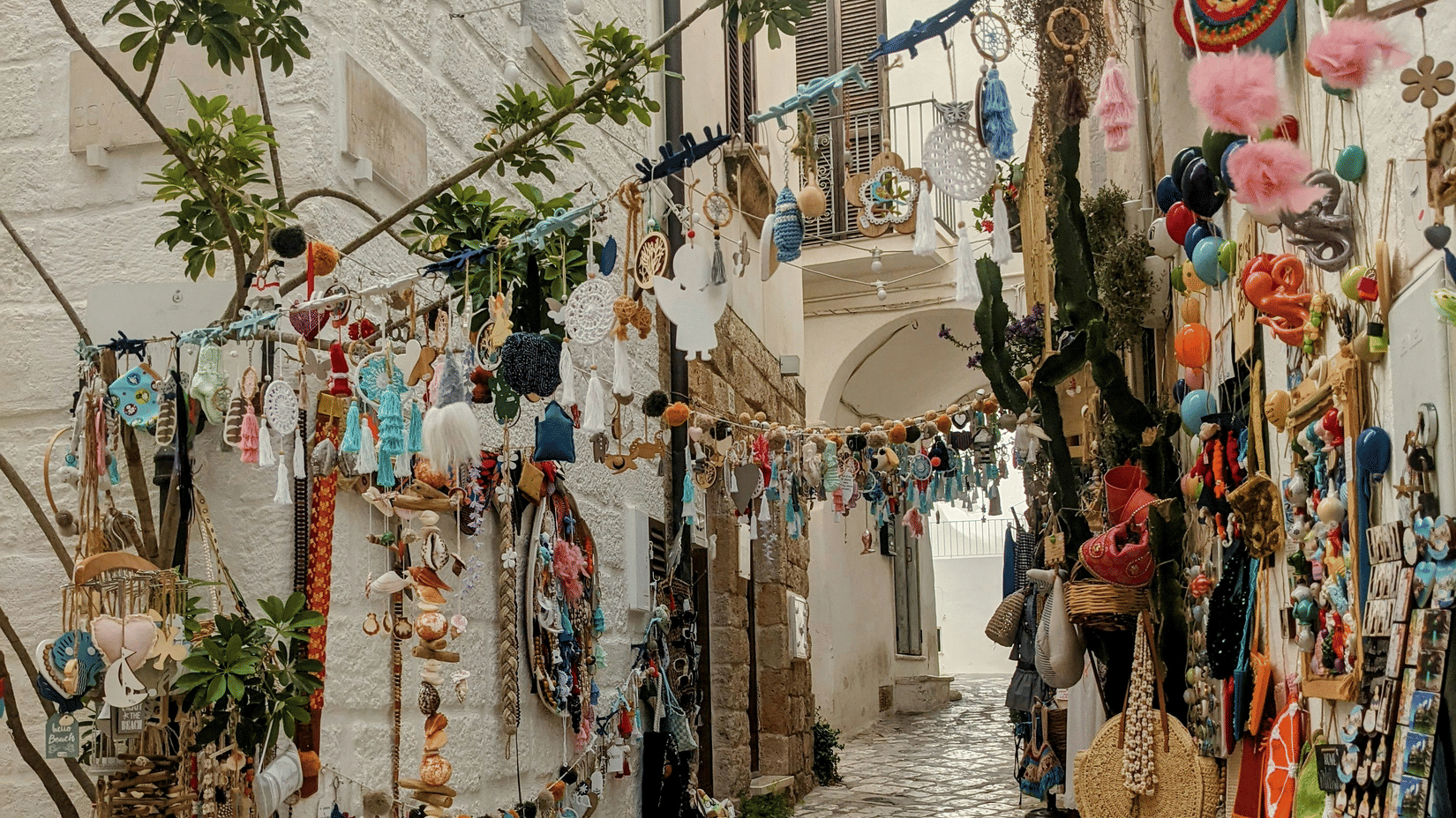 A narrow alley with walls, decorated with handmade crafts