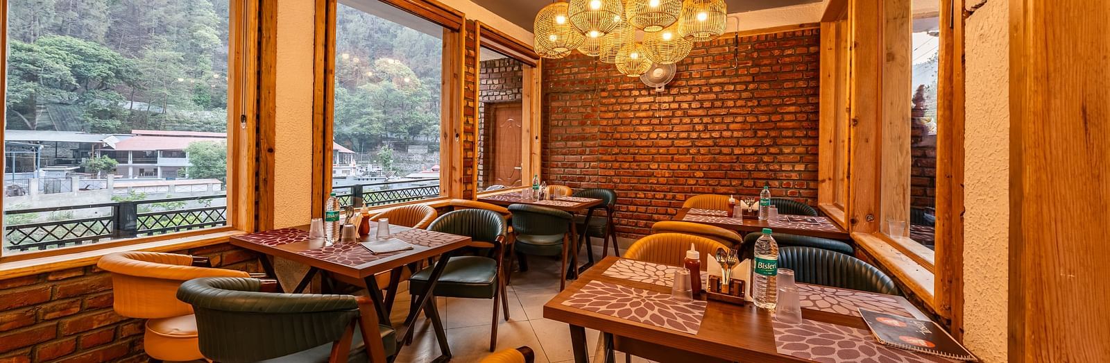 Corner view of the Kesari Restaurant by JVR Stays featuring a chandelier hanging from the ceiling.