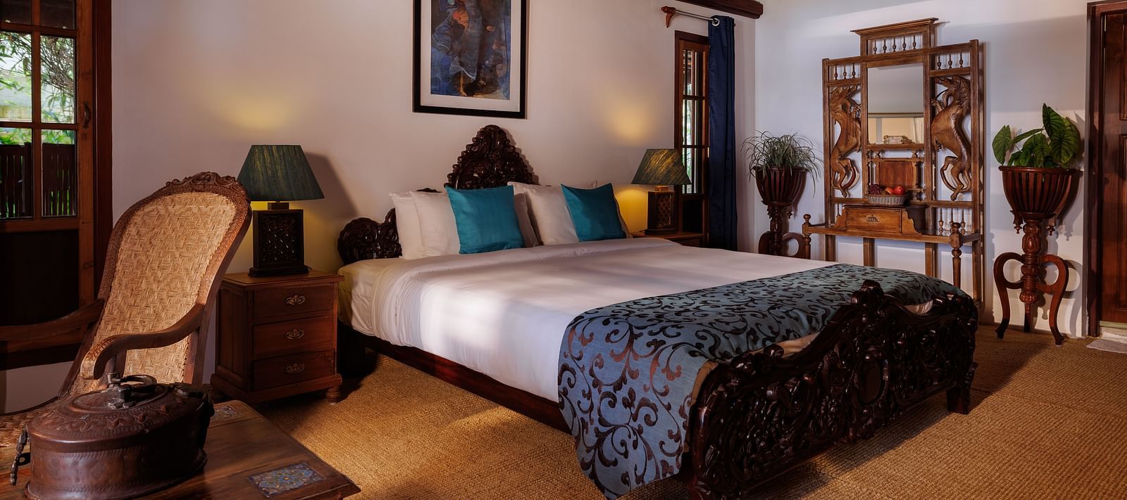 A room with a bed, a wooden dresser, a chair, and a coffee table - BluSalzz Villas - Muhamma Resort, Alleppey