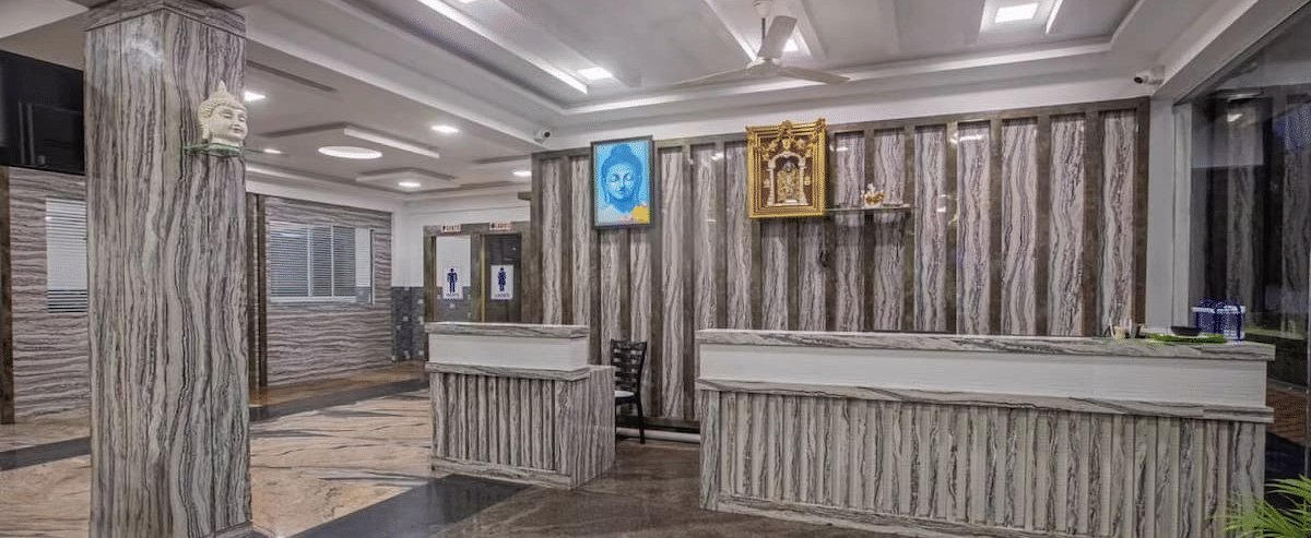 Elegant hotel reception area with wooden decor and modern lighting at Siri Ambari Resorts and Spa.