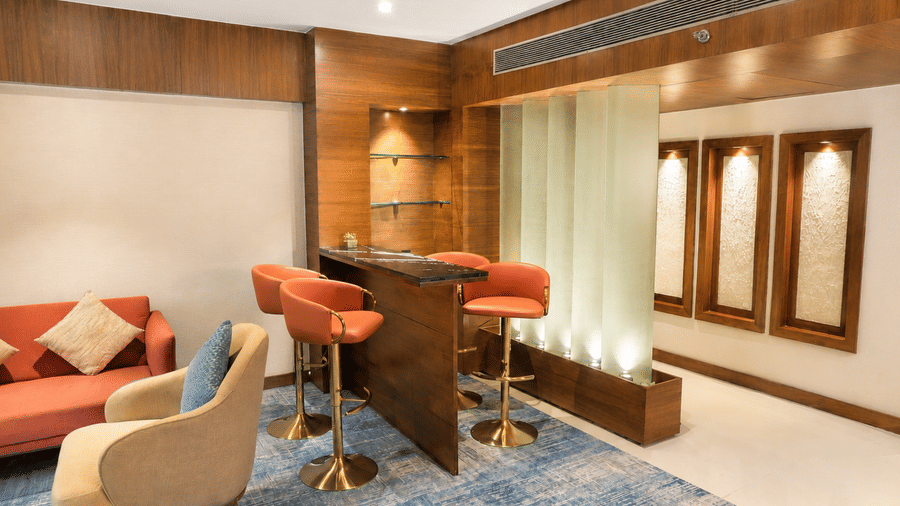 Celebrity Suite at Pride Premier Pune featuring a living room with sofa sets, a counter table with chairs around.