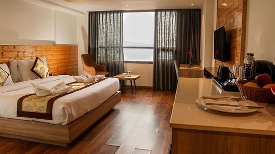A bedroom featuring a double bed along with a wall mounted television in front of it - Sumitel Sanderling