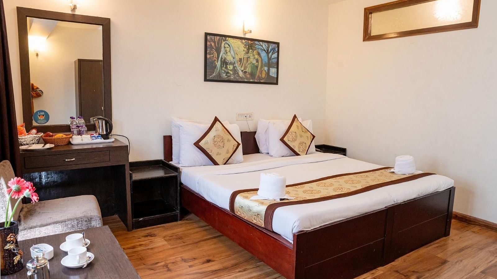 A full view shot of the Deluxe Room with a half length mirror beside the bed and the bed side table at Sumitel Sanderling.