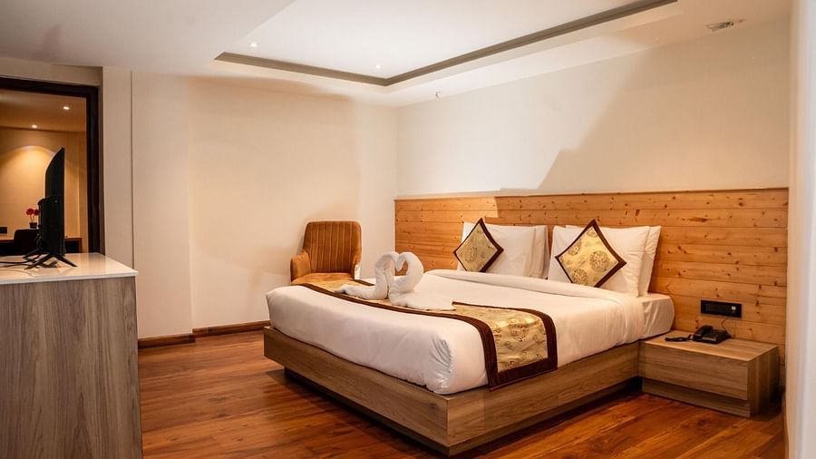 Corner view shot of the Deluxe Room with a plush double bed with a bed runner over it at Sumitel Sanderling.