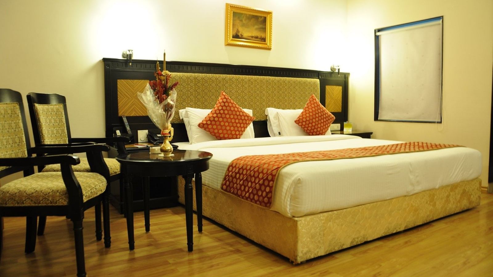 Royal Suites with comfortable bed and chairs at SRM Hotel Trichy