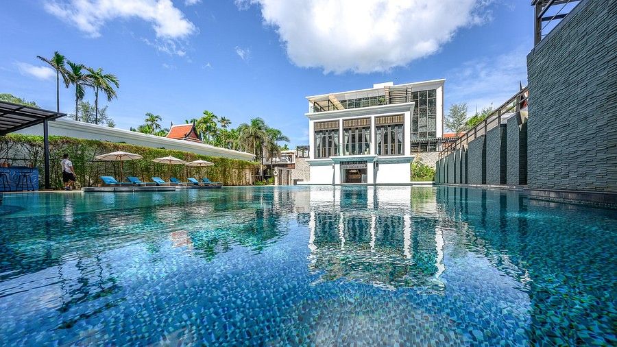 an image of the beautiful swimming pool under a clear blue sky with clouds - Maikhao Dream Villa Resort & Spa, Phuket
