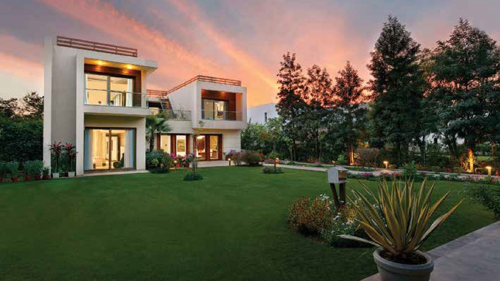 A facade view of a villa during twilight - Karma Lakelands.
