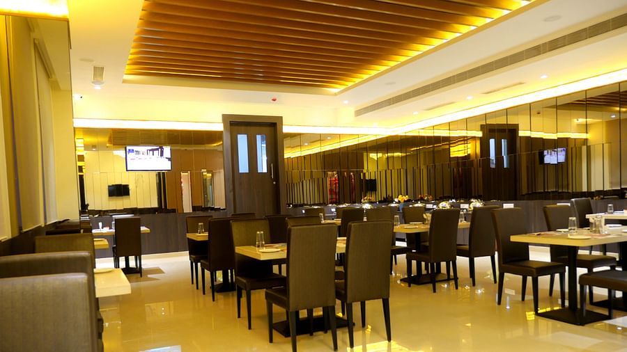 dining of a restaurant with warm lights of ASR Parklane, Hosur