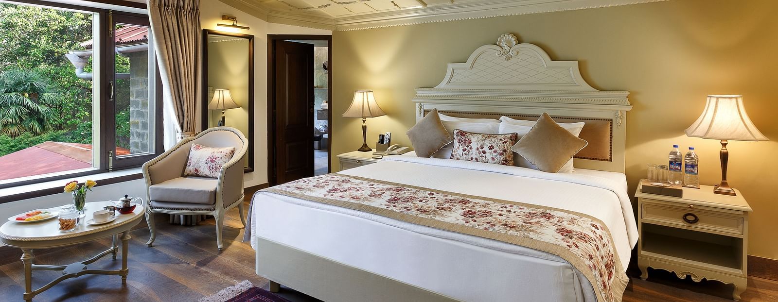 A cosy room with comforting decors, king size bed, wooden ceiling - The Naini Retreat