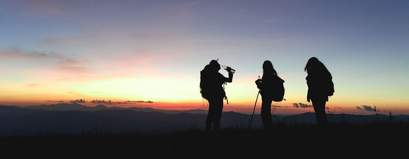 An image of three people out for trekking in the evening 
