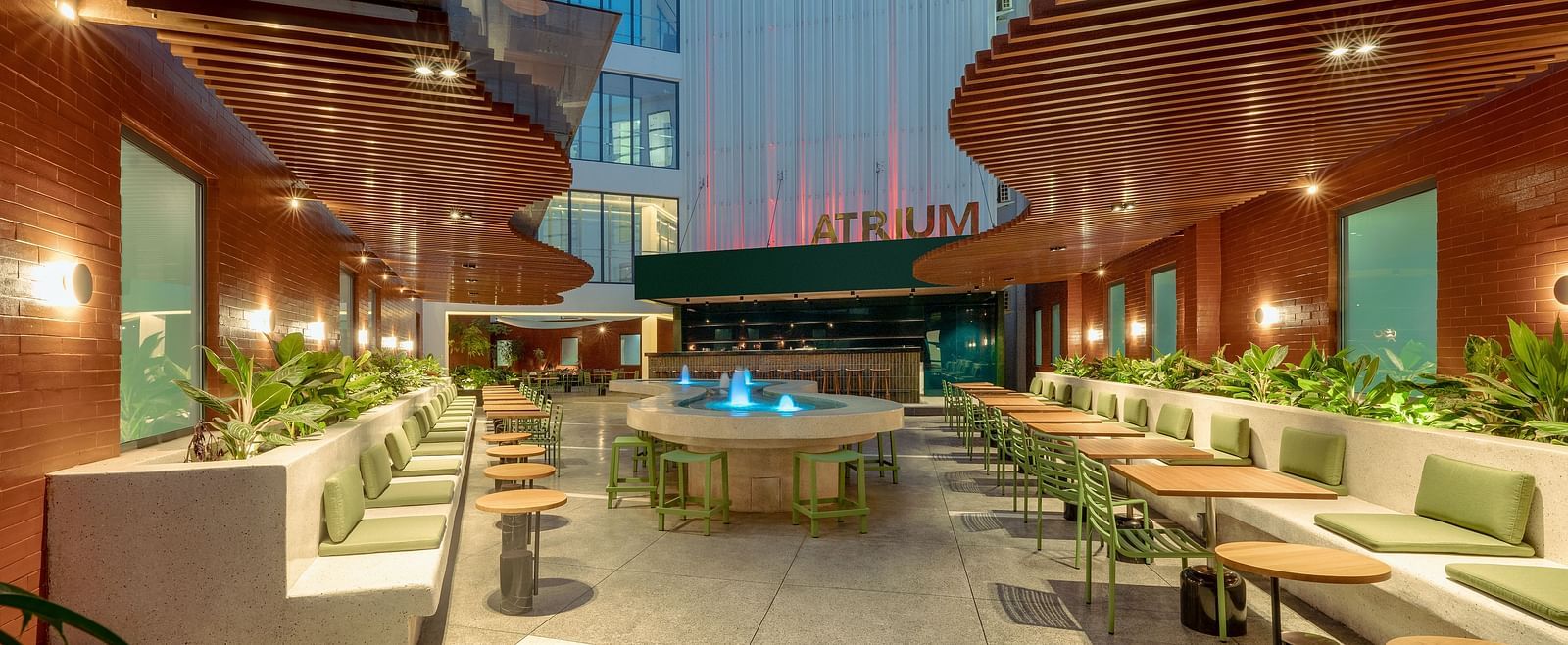 The Atrium at night with modern outdoor seating and ambient lighting. - The Pelican Hotel, Accra