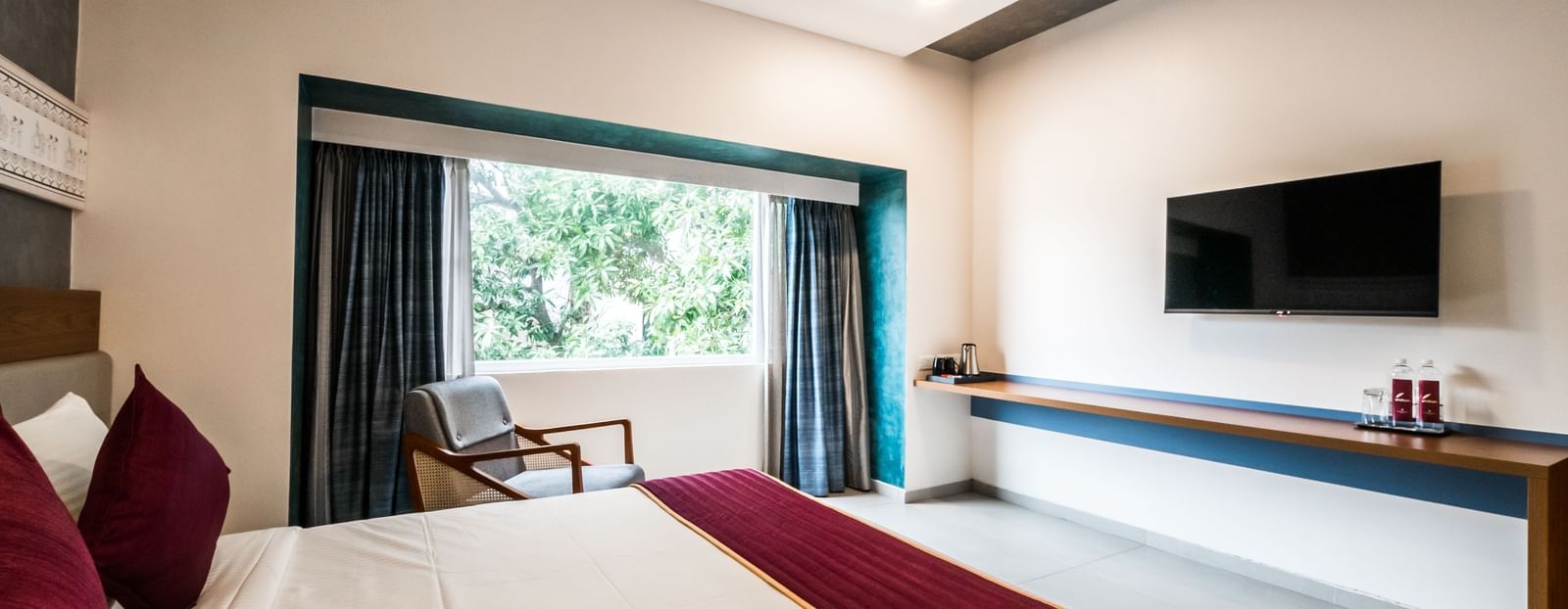 A view from the bed in a hotel room, showing the television and a long console table at Shilton Dee Cee.