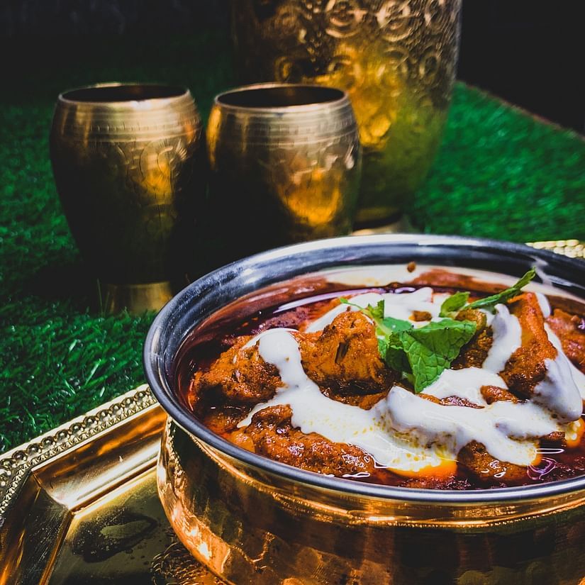 a bowl of curry and other untensils 