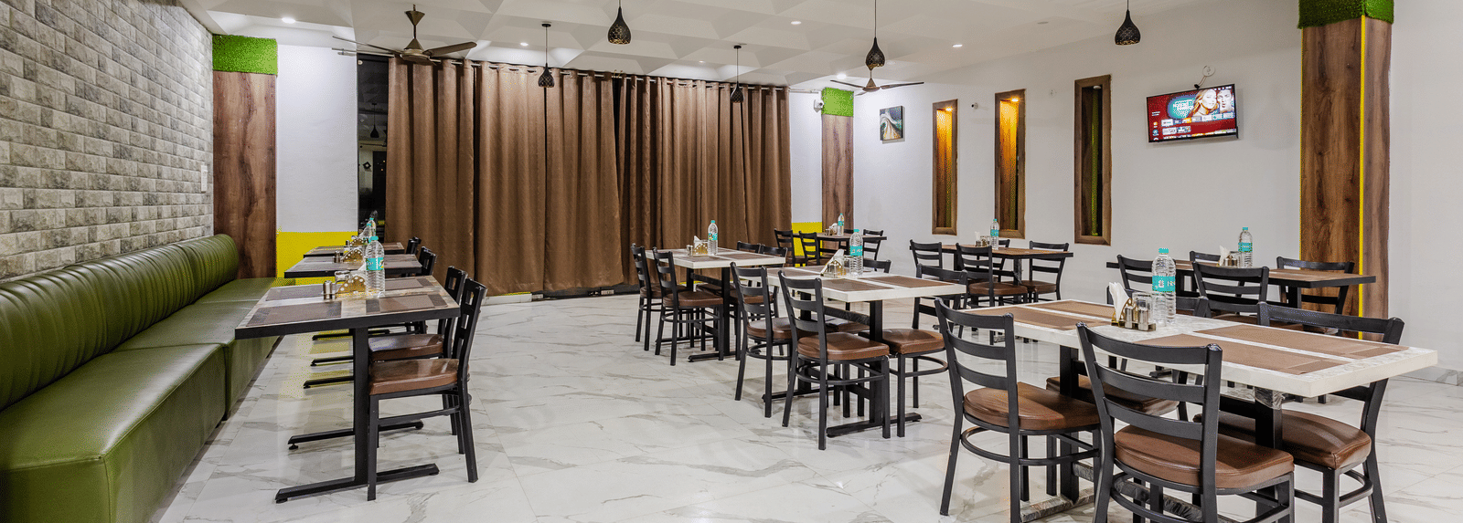 The indoor restaurant at Lime Tree Hotels and Banquet, Vrindavan with well defined seating area.