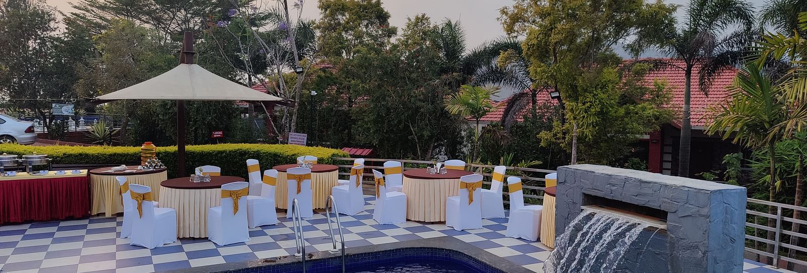 Outdoor event space featuring a pool and seating areas | Open Deck | Woodstock Resorts, Coorg