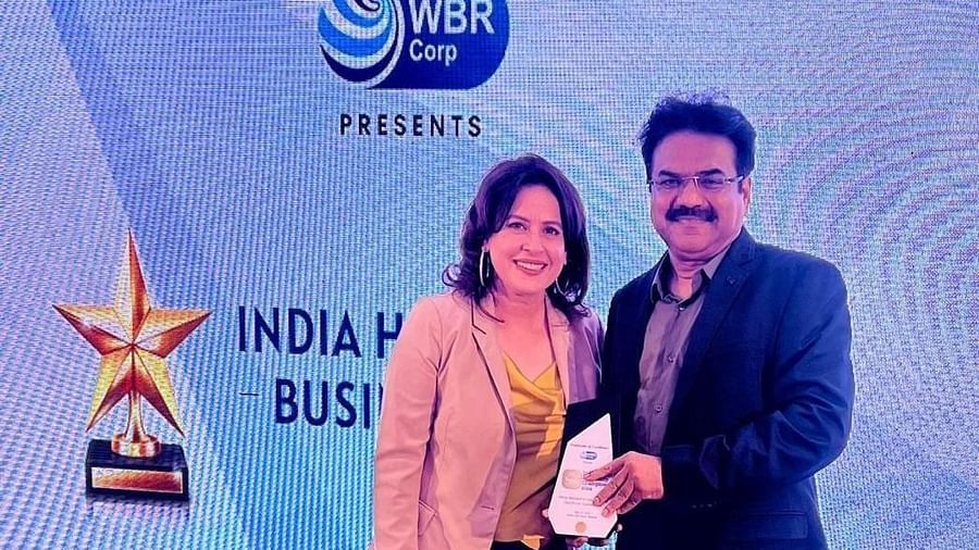 Image of a member of the resort receiving an award in an event  The Grand Legacy Resort and Spa