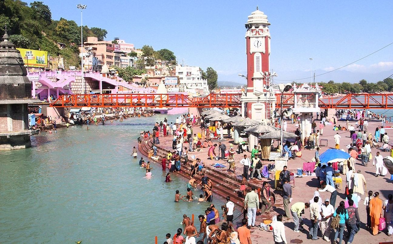 a crowd of people taking dips in a river turn by turn