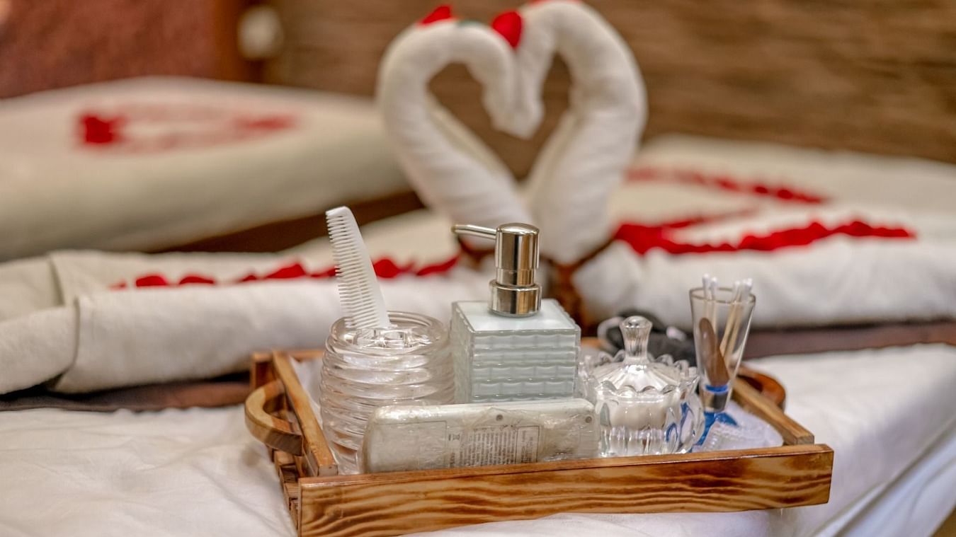 Image of two towels in the shape of swans and other spa  bottles kept on a spa bed at IOSIS Spa & Wellness Raipur