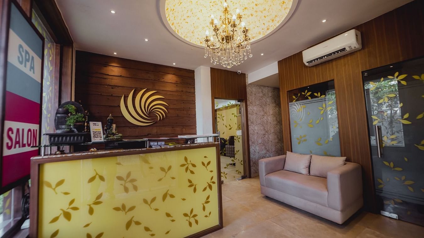 reception area with a large chandelier hung on the roof - IOSIS Spa & Wellness
