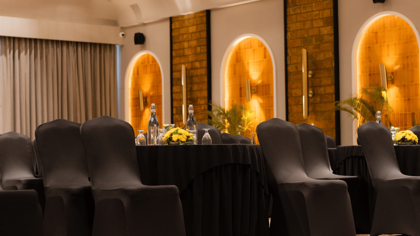 Ballroom with elegantly arranged chairs, complemented by floral carpets that adds a touch of luxury