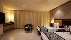 A image of our executive room with twin beds, comfortable sofa and a television - Grand Continent, Malleshwaram