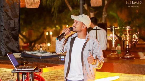A person singing in Themis Mudhouse - A Nature's Retreat Resort & Wellness