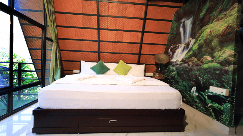 a double bed with a gramophone next to it - Holistic Stay Eco Resort, Kannur