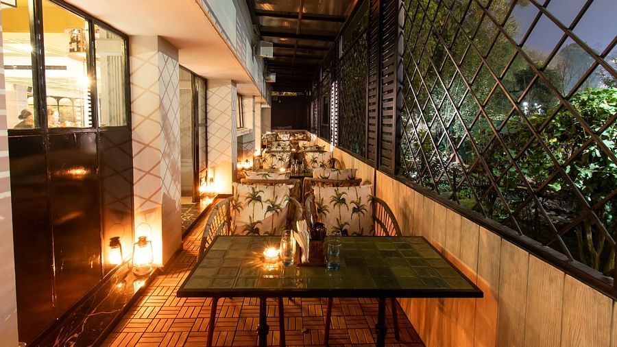An image of a balcony with beautifully decorated tables and chairs at Hotel Polo Towers, Shillong.